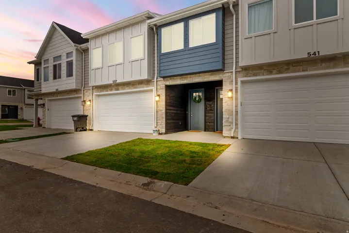 Modern multi-story exterior with stone veneer and horizontal siding accents