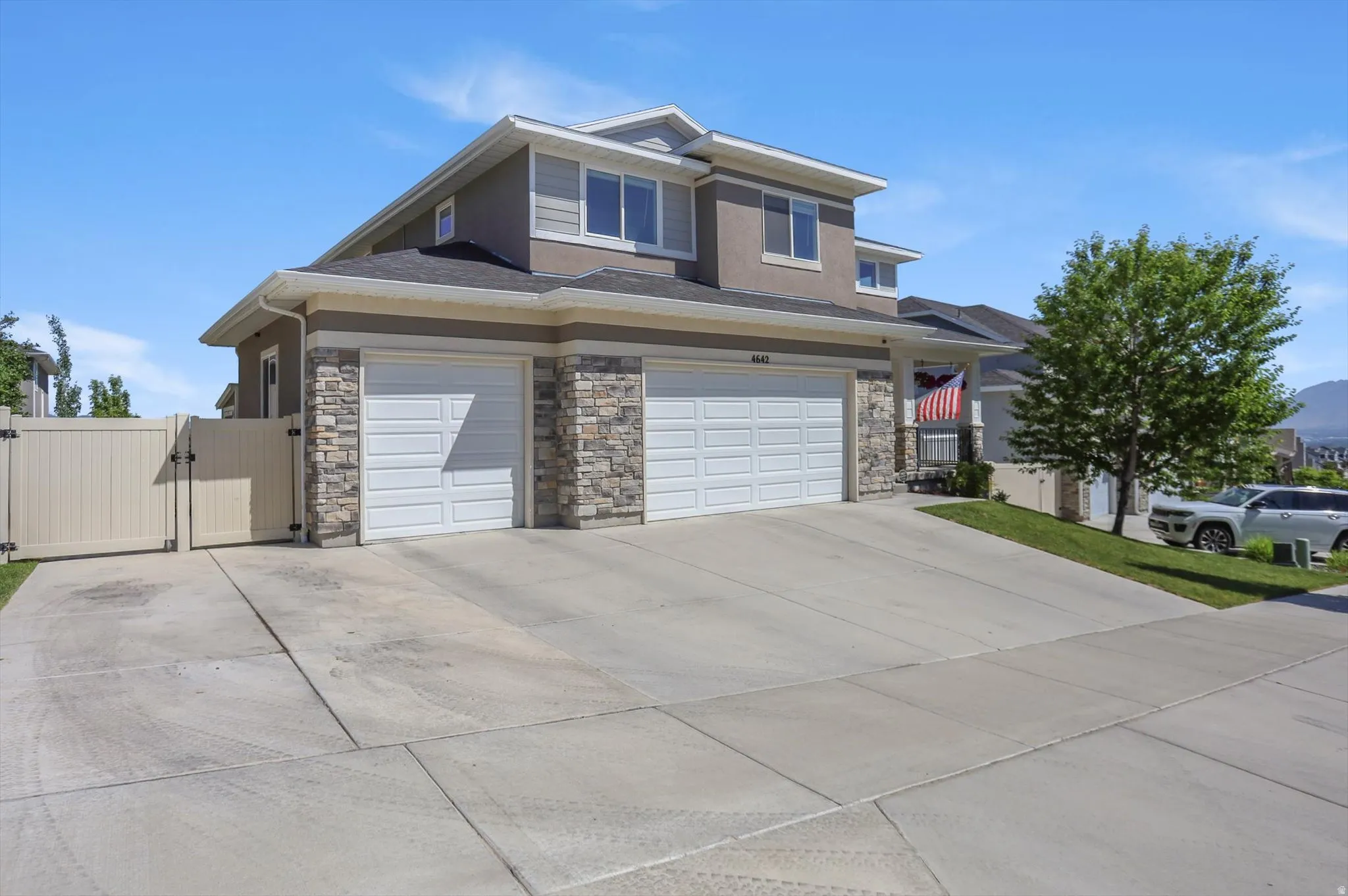 Contemporary two-story residence featuring a stucco and stone veneer exterior