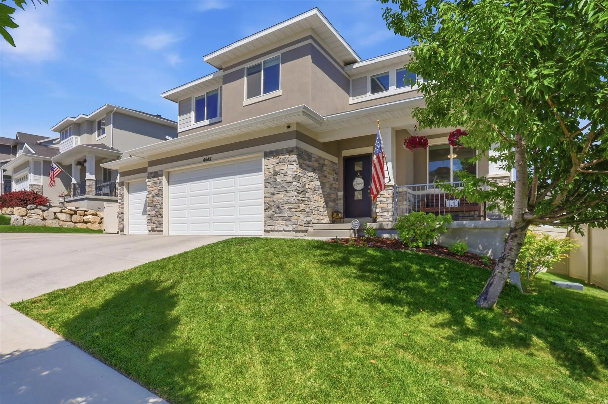 Contemporary two-story exterior with stone veneer and stucco siding