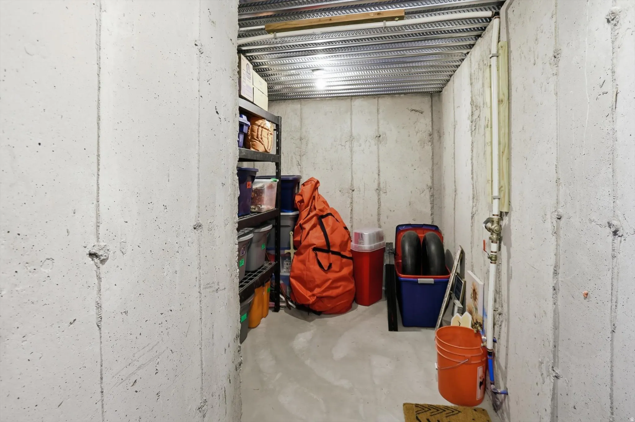 Concrete foundation walls and flooring provide a durable storage area