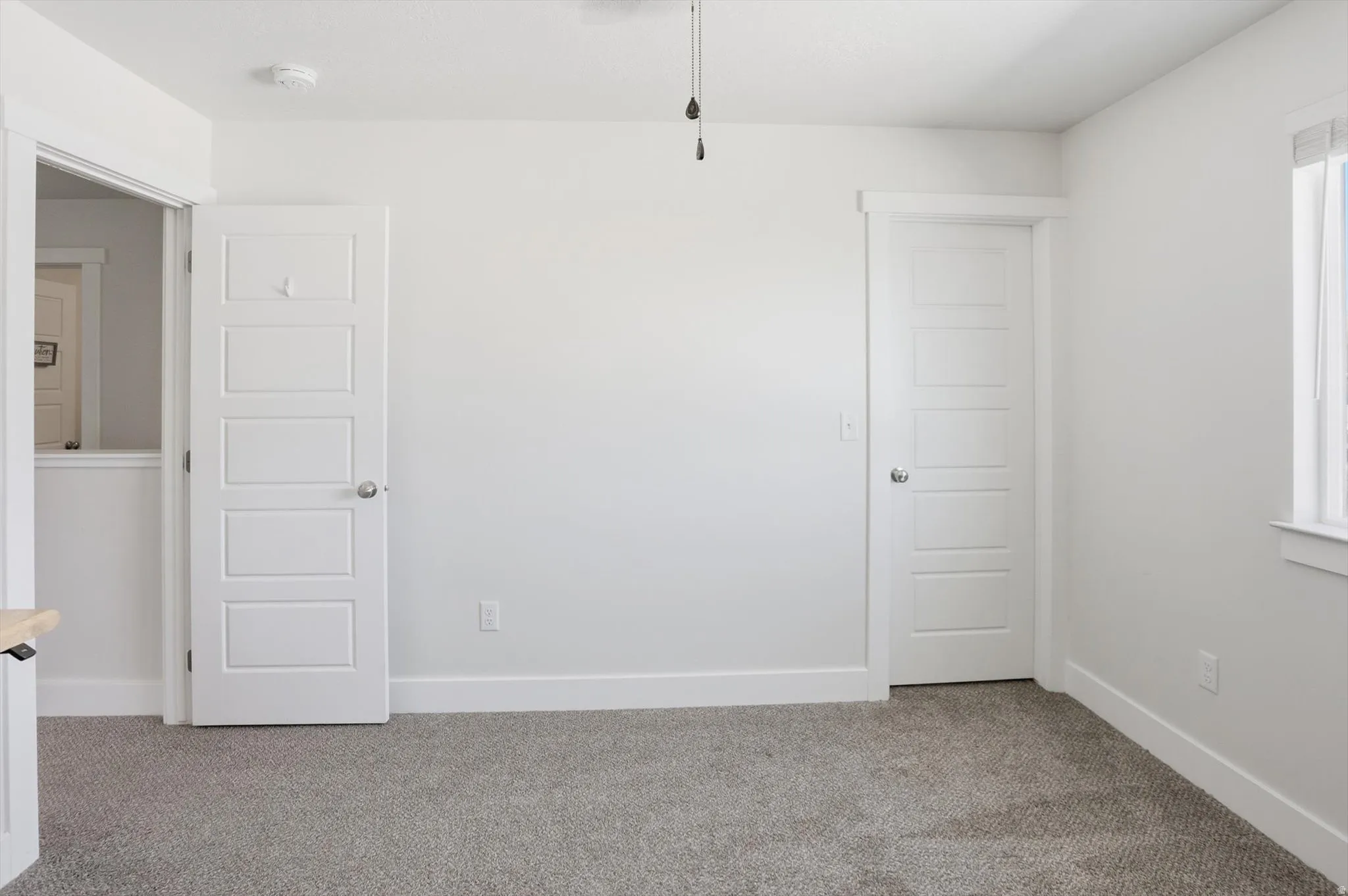 Room featuring light-toned carpeting and neutral wall tones