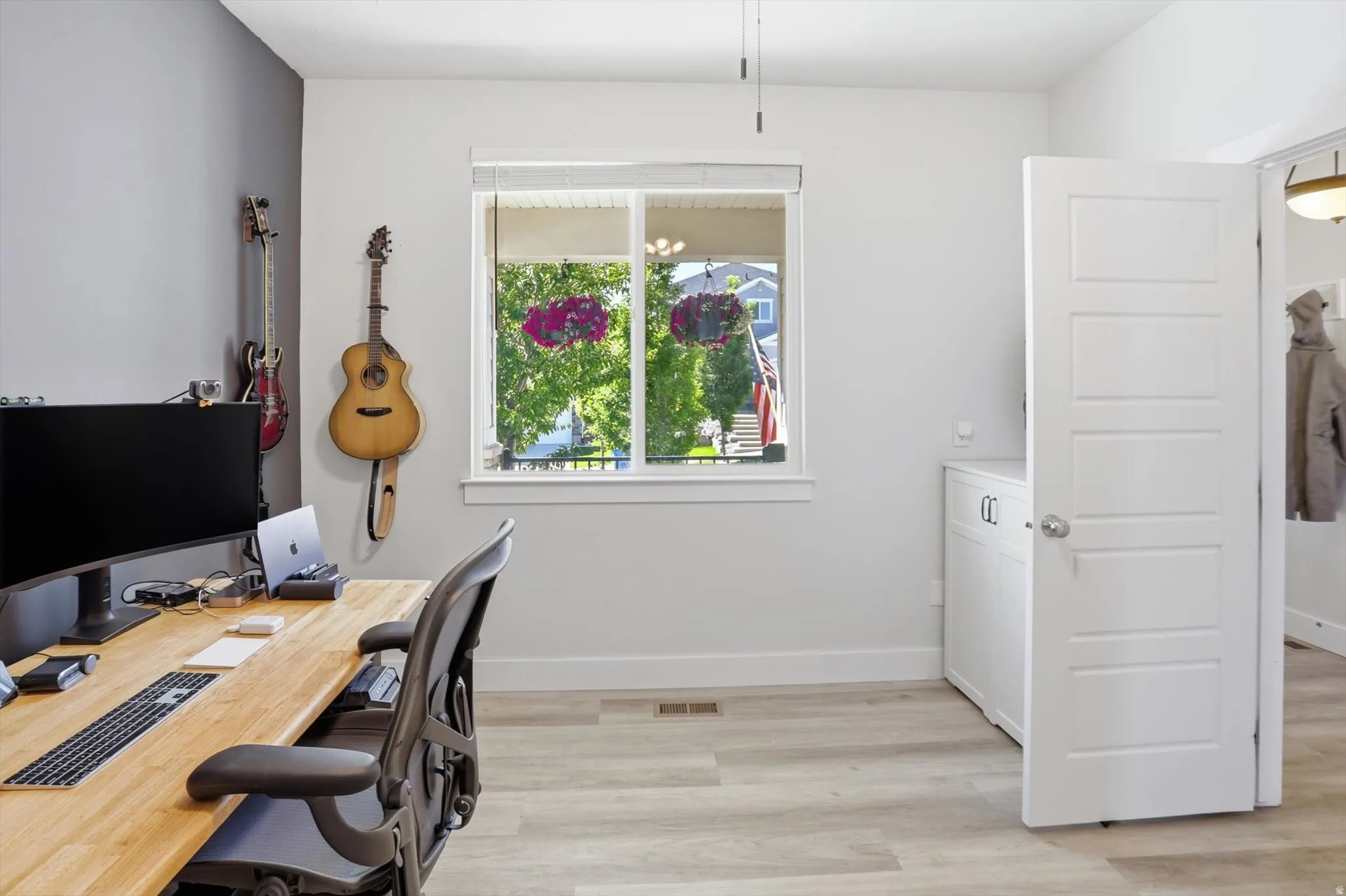 Light-toned wood-finish flooring complements a neutral color palette