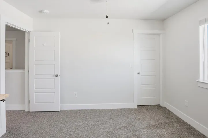 Room featuring light-toned carpeting and neutral wall tones