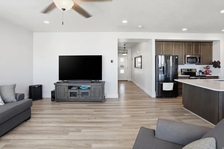 Open concept living area featuring wood-finish flooring, recessed lighting, and a ceiling fan