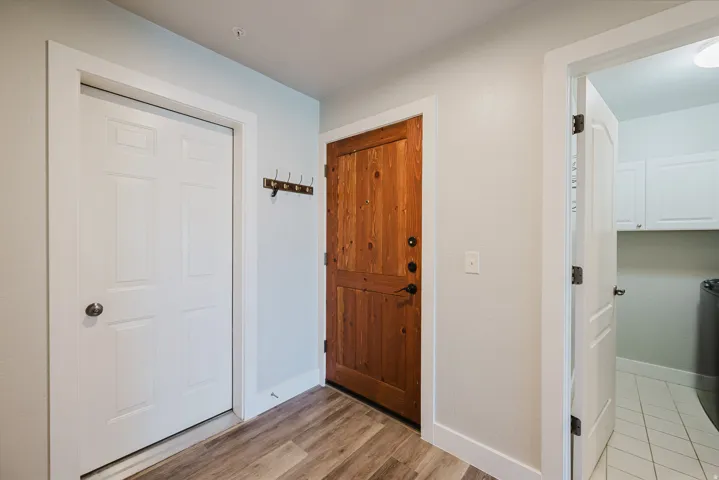 Unit has attached garage. White door is garage, brown door is entry door, opoen door is laundru room