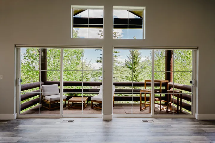 Side by side sliders plus windows near vaulted ceiling bring in lots of natural light and provides great views.