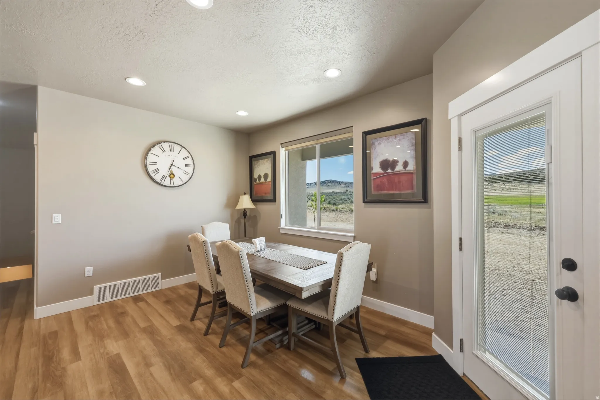 Dining area featuring wood-finish flooring, recessed lighting, and a neutral wall palette