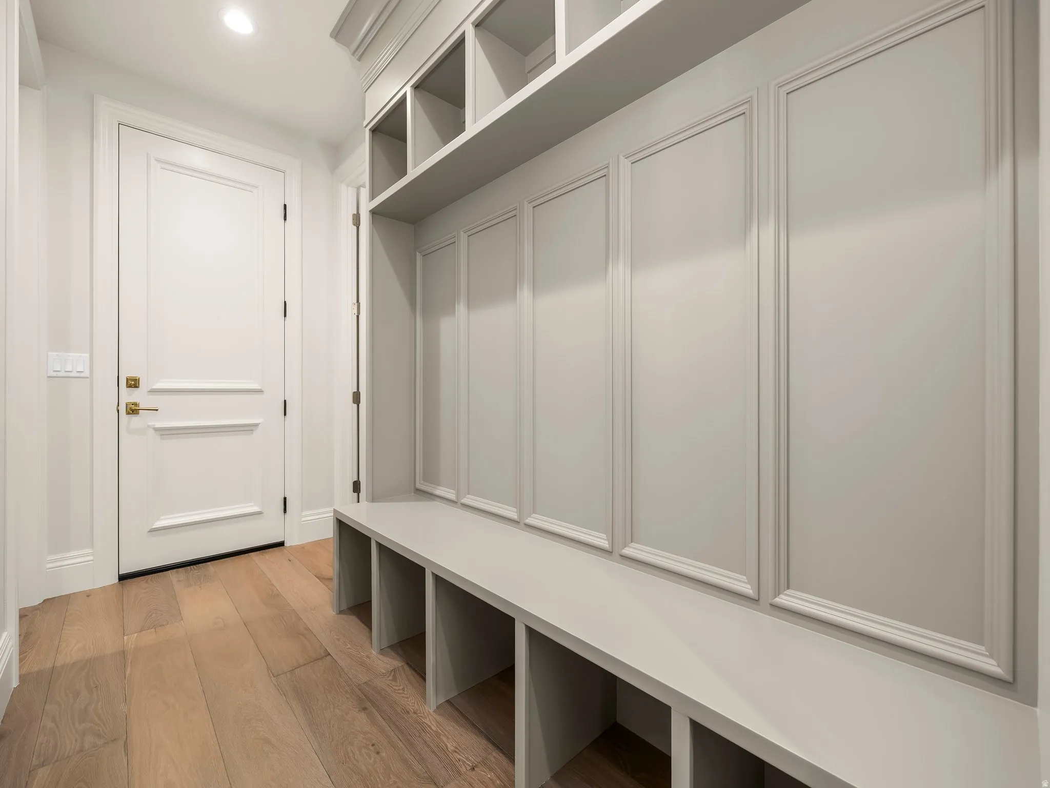 Built-in mudroom storage featuring a bench, open cubbies, and overhead shelving
