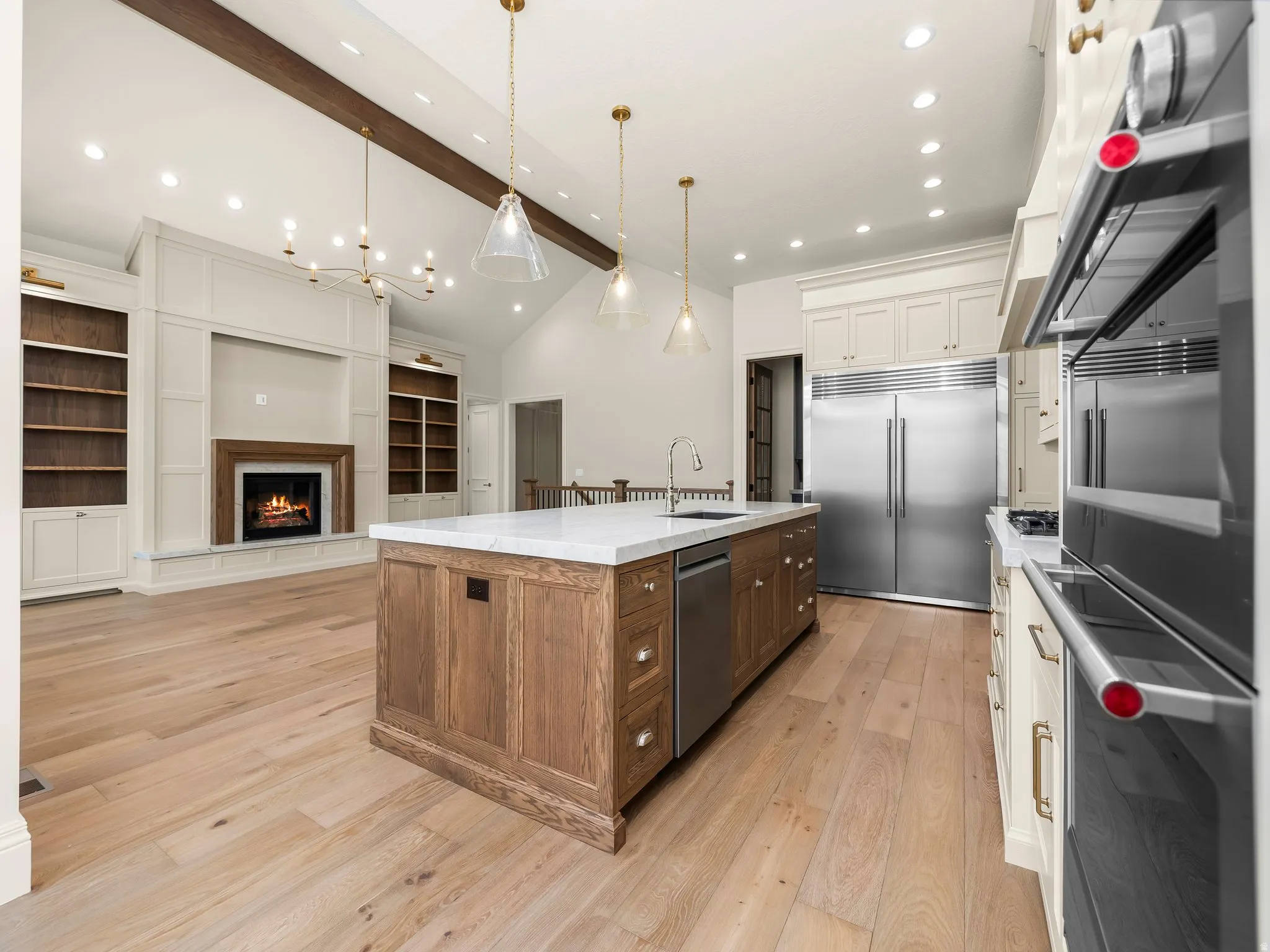 Open-concept kitchen and living area featuring light wood-finish flooring