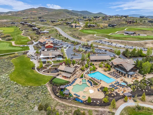 Expansive community amenities including a multi-level pool with integrated slide, a separate resort-style pool, and a hot tub