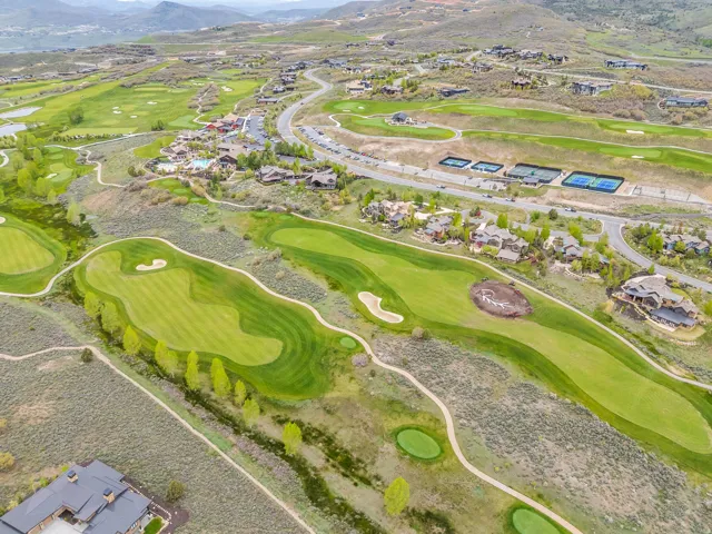 Expansive golf course landscape with multiple greens and sand traps