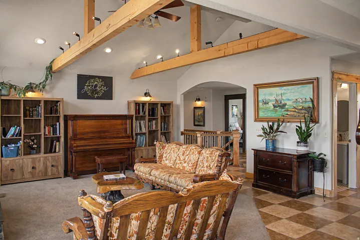 Vaulted ceiling featuring exposed wood beams and recessed lighting