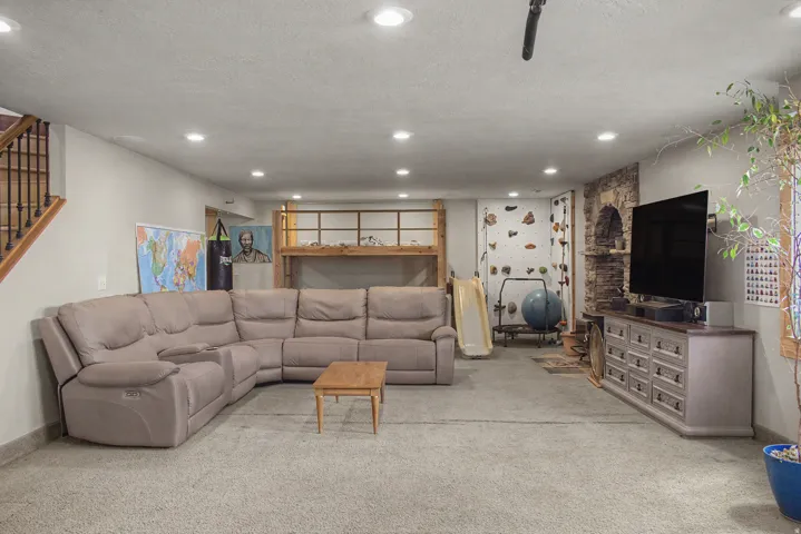 Spacious lower-level area featuring recessed lighting and durable carpet flooring