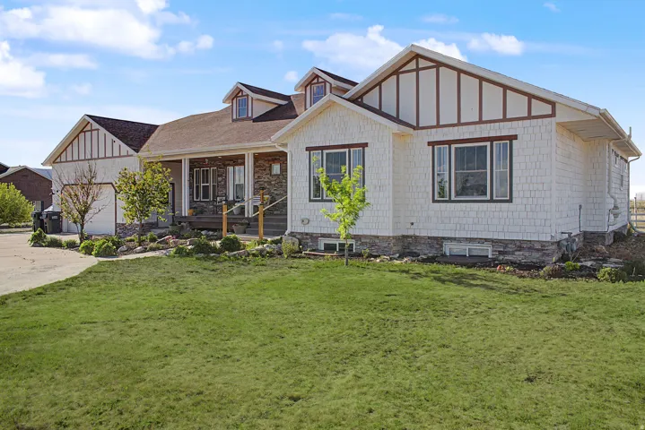 Exterior featuring shake siding, stone accents, and dark trim details