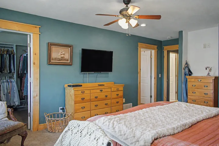 Bedroom featuring teal accent wall, recessed lighting, and wood-finish trim