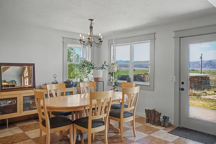 Dining area featuring checkerboard flooring and multiple windows