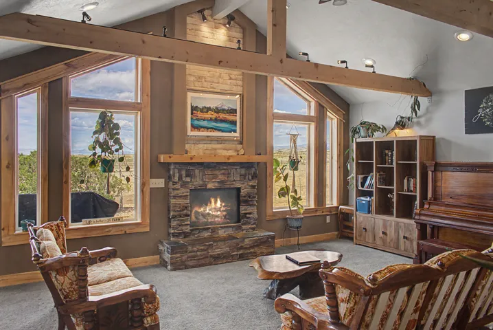 Vaulted ceiling with exposed wood beams and track lighting