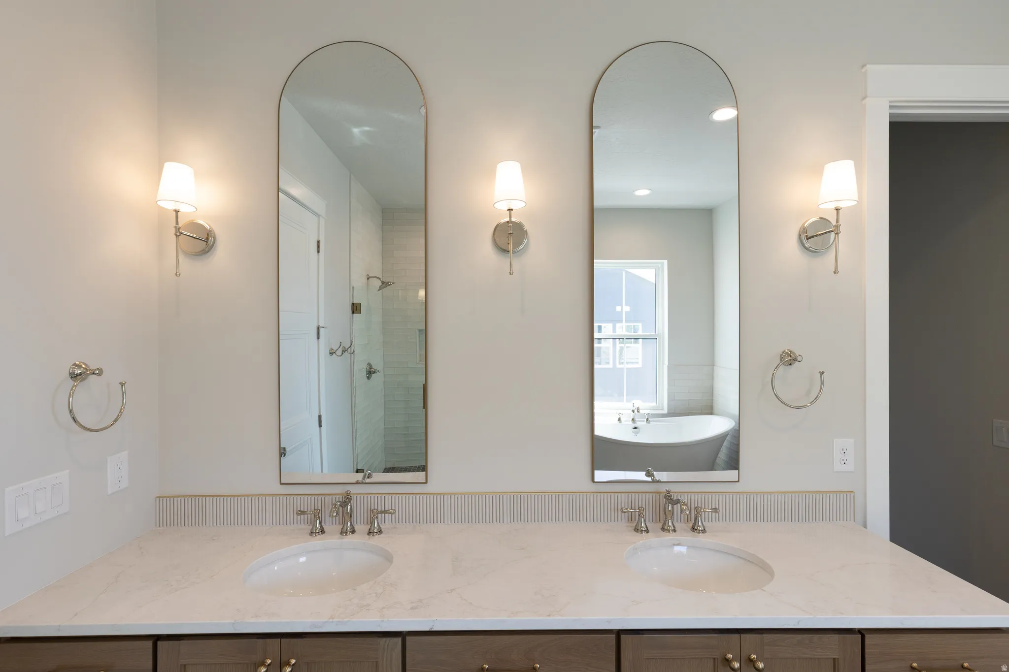 Dual vanity featuring neutral-toned countertops, two undermount sinks, and brushed nickel fixtures