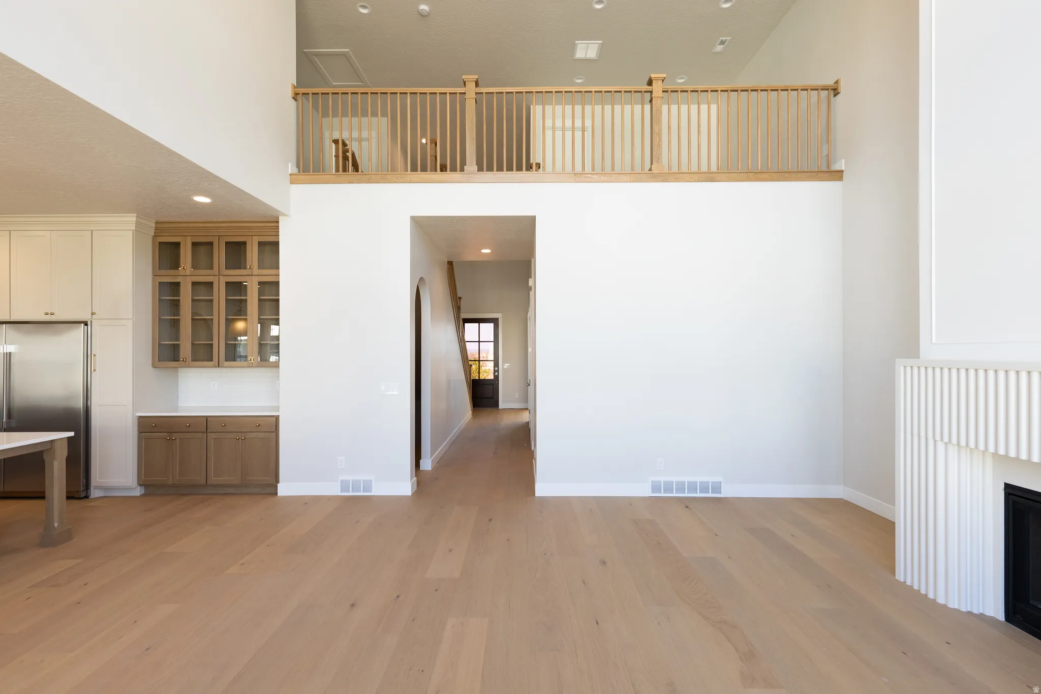 Light wood-finish flooring extending through an open-concept living space
