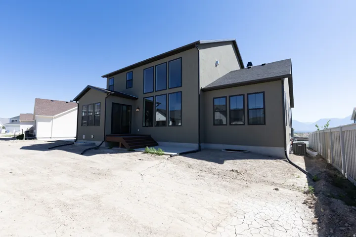Contemporary two-story exterior with stucco finish and dark trim windows