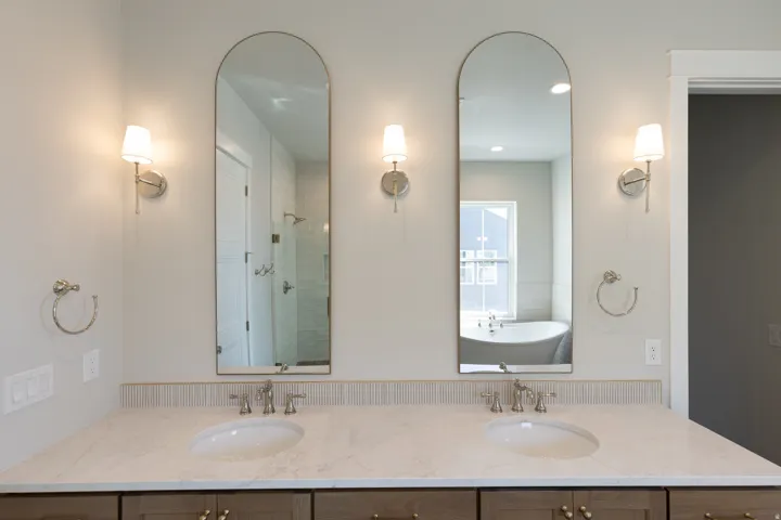 Dual vanity featuring neutral-toned countertops, two undermount sinks, and brushed nickel fixtures