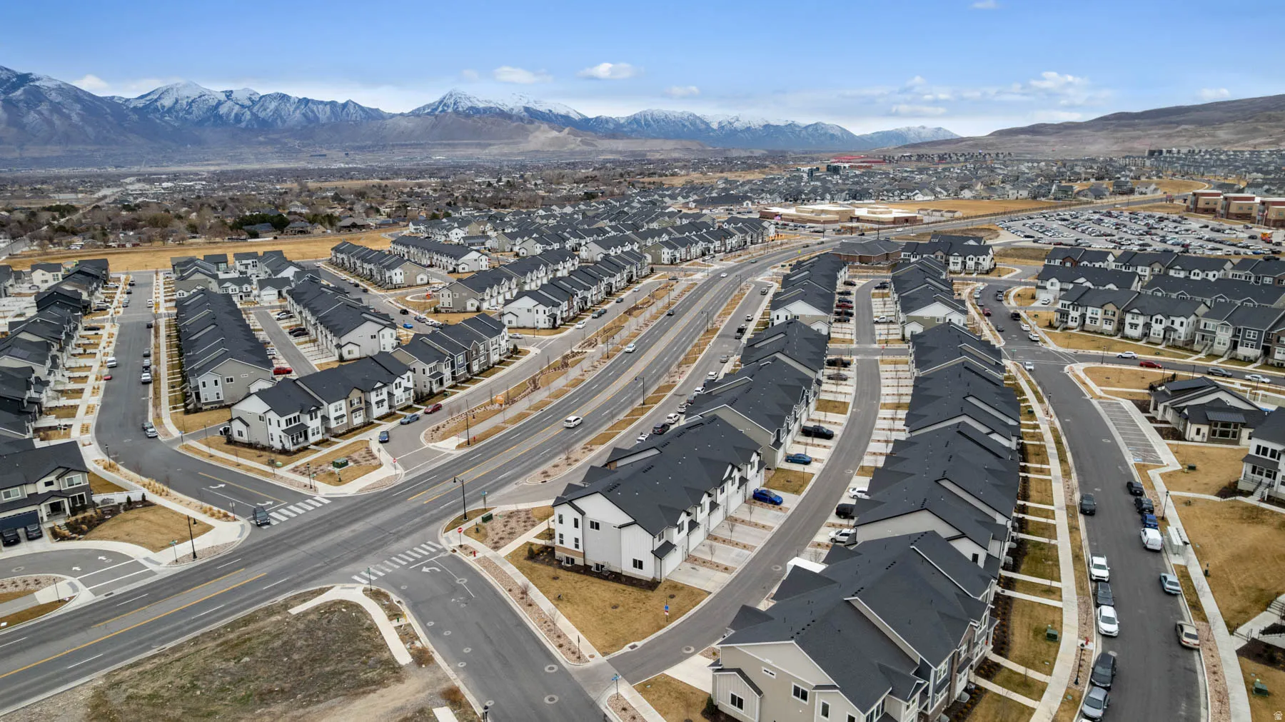Expansive aerial captures a developing residential community featuring numerous multi-story homes