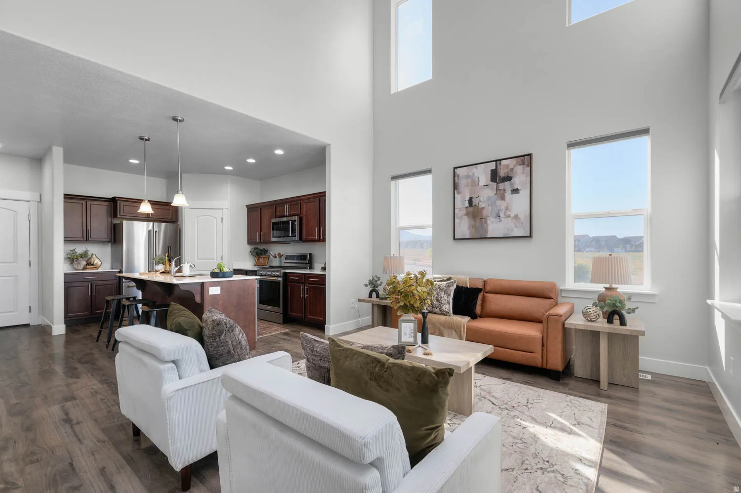 Two-story living area with high ceilings and wood-finish flooring
