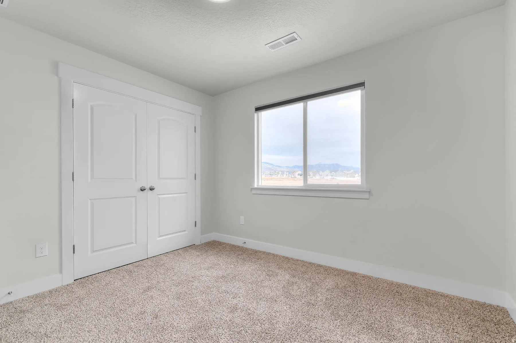Light-toned wall finishes complementing a neutral carpeted floor