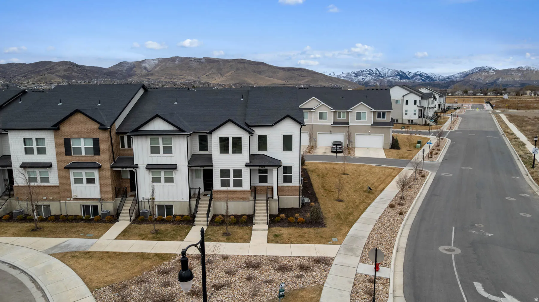 Townhouse community featuring varied facade treatments including brick and siding