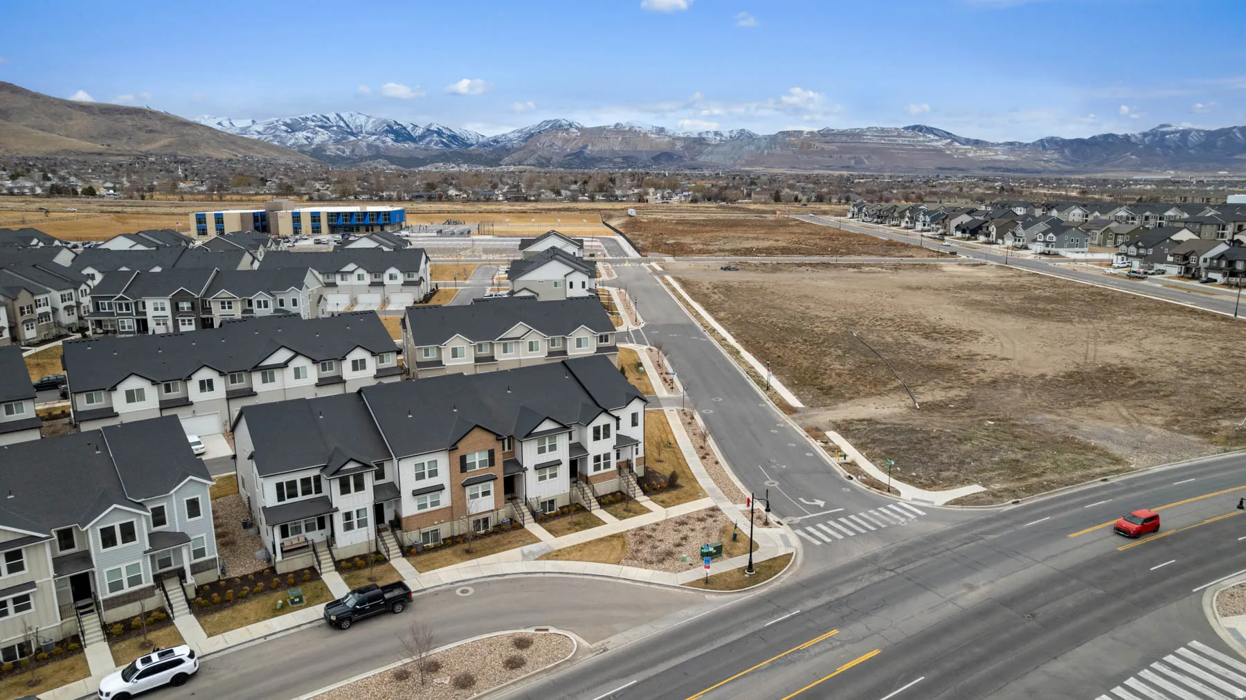 Newly developed residential area featuring modern townhomes and single-family residences