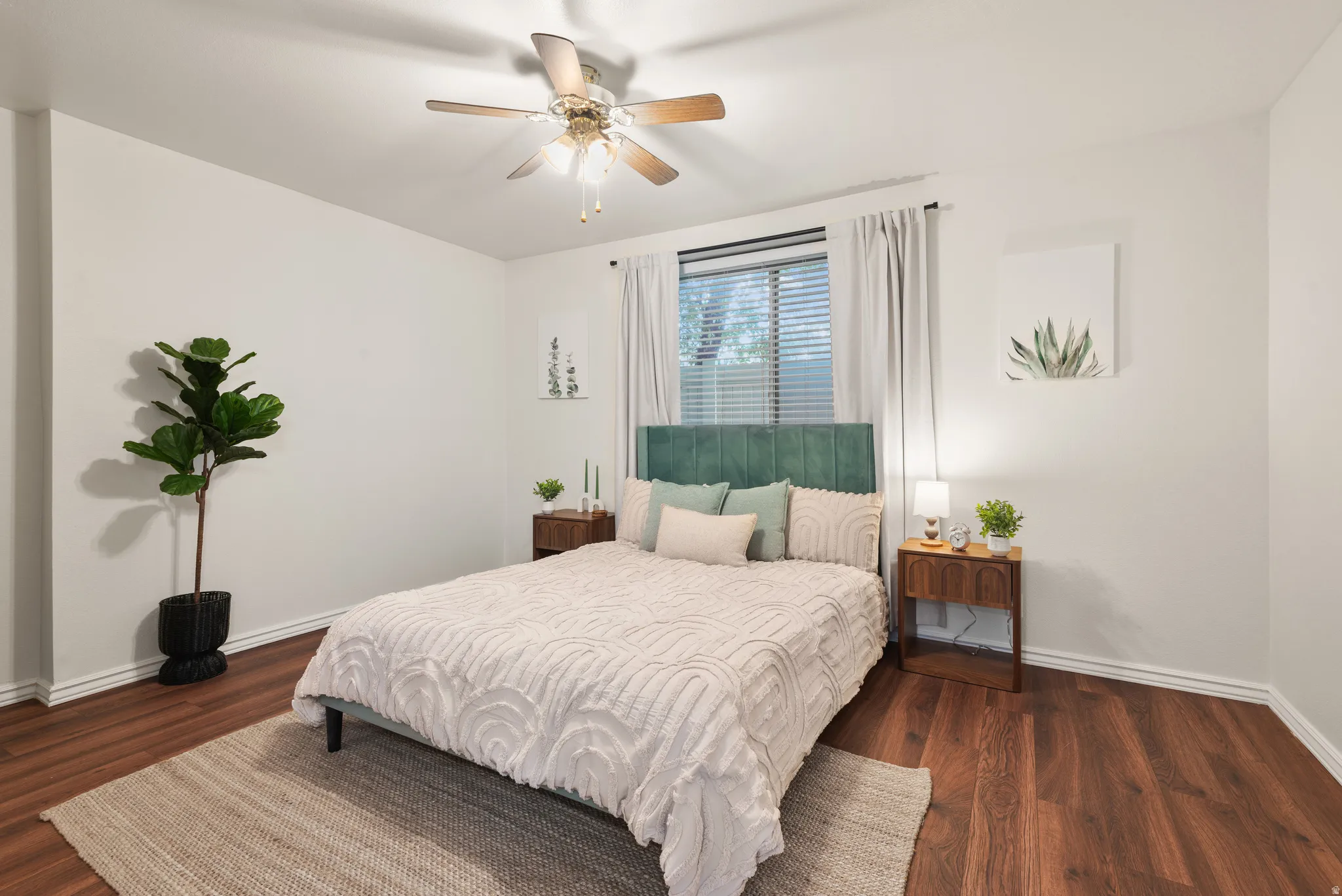 Primary Suite featuring wood-finish flooring, white baseboards, and neutral wall paint