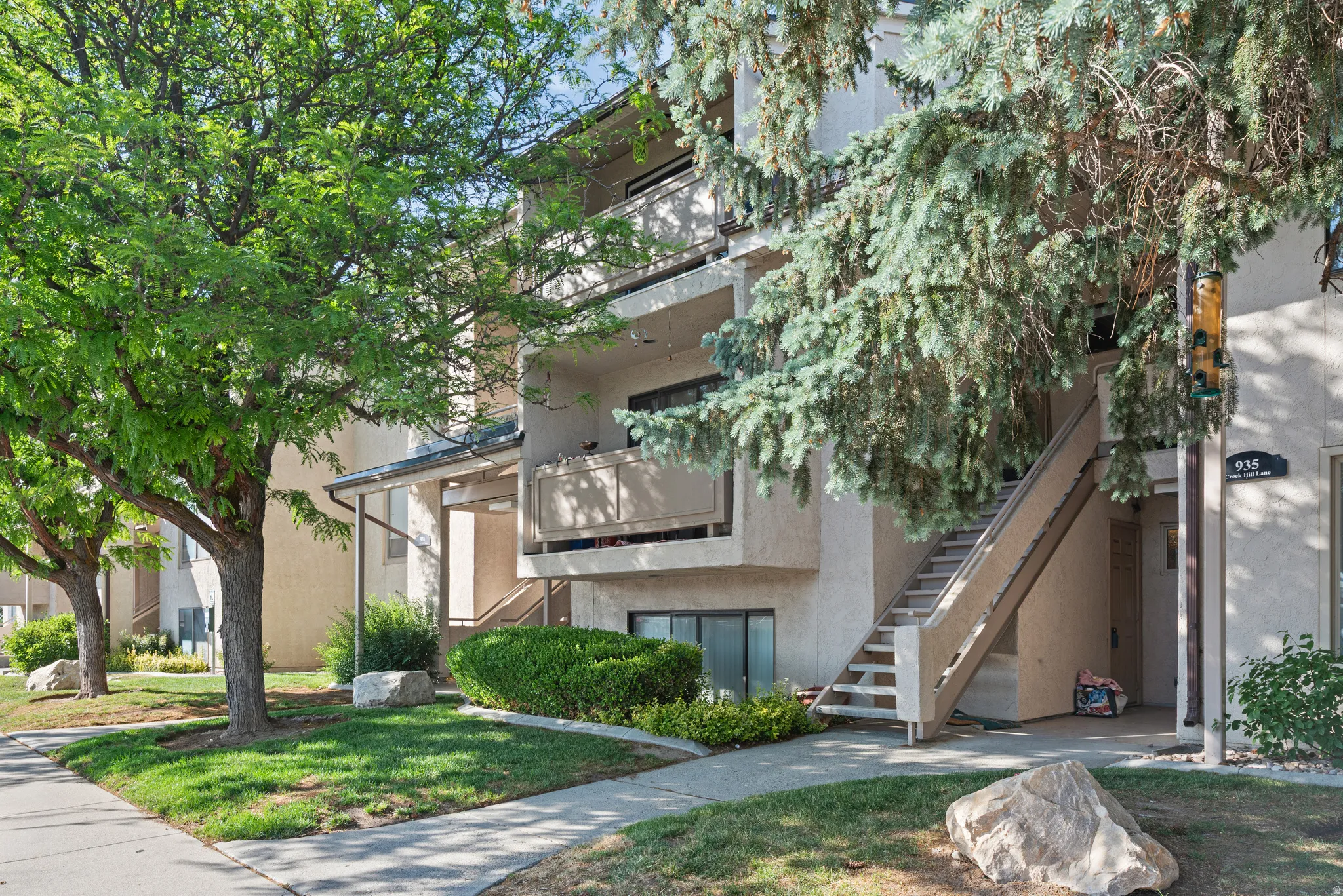 Multi-level residential building featuring a neutral stucco exterior