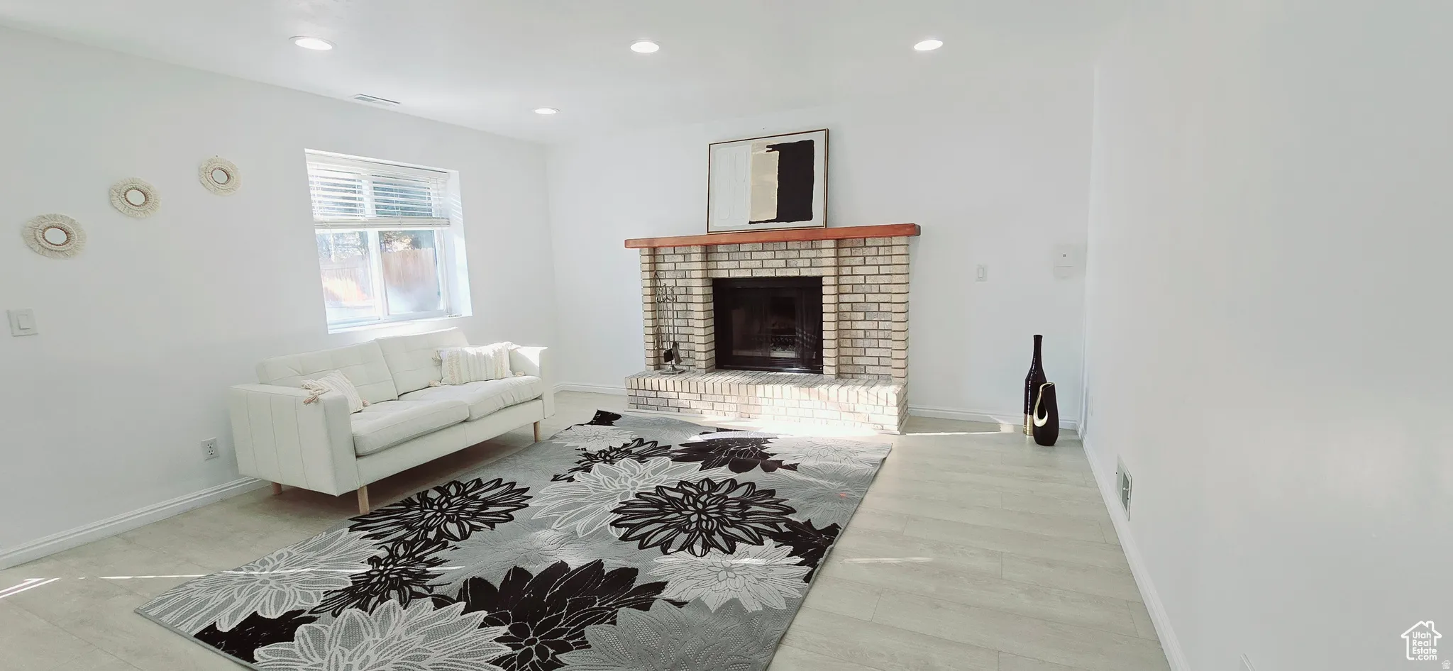 Brick fireplace with a wood mantel
