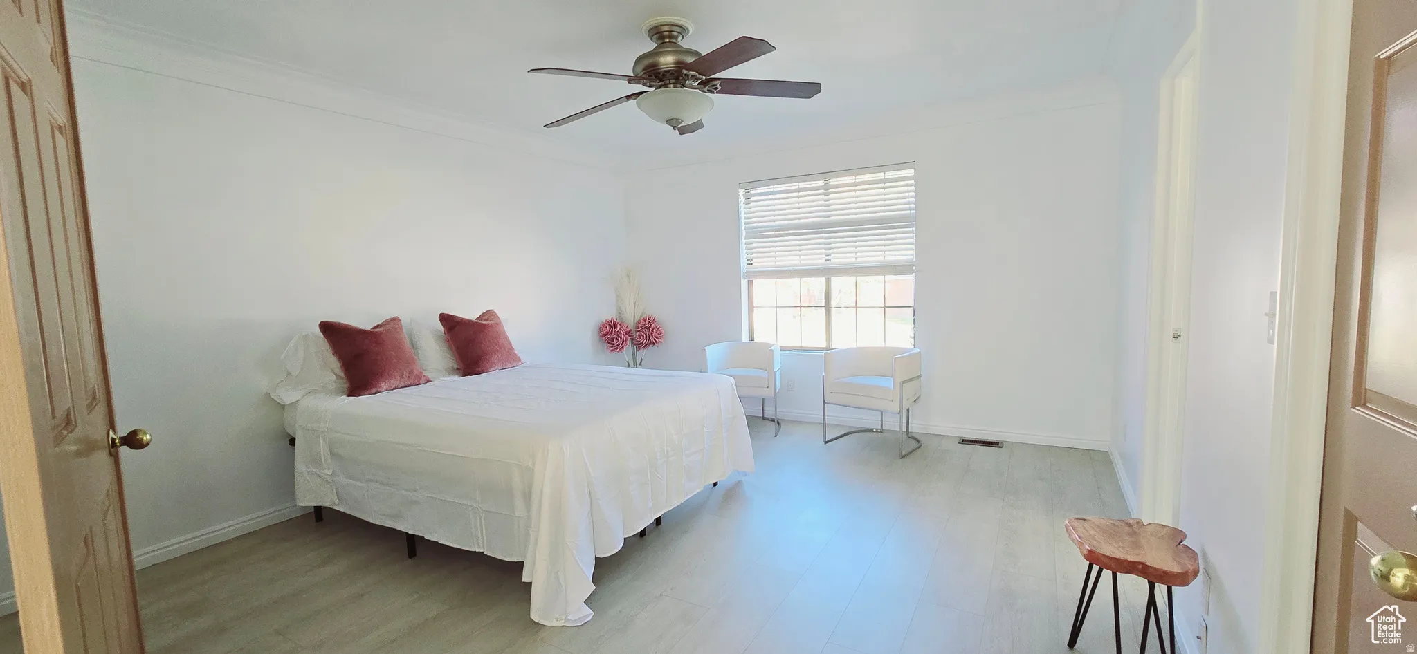 Bright room featuring light wood-finish flooring and white walls