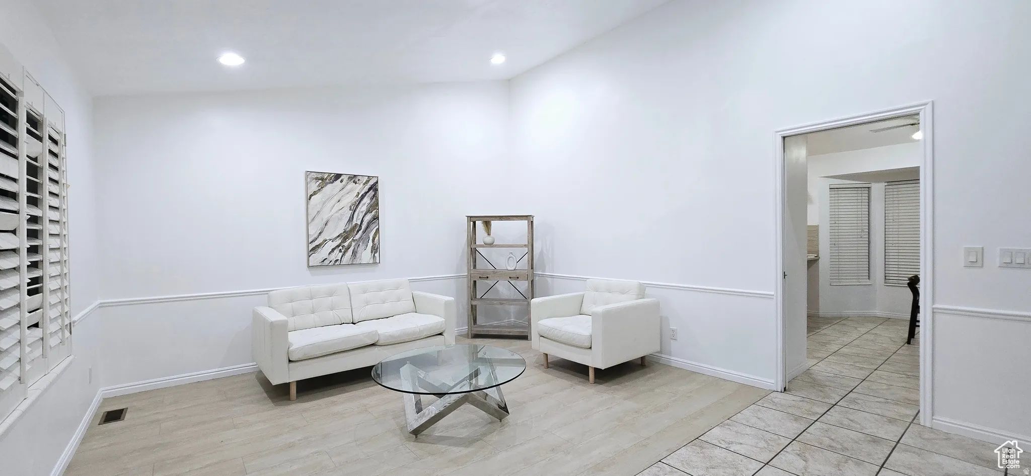 Bright interior space featuring recessed lighting and wainscoting