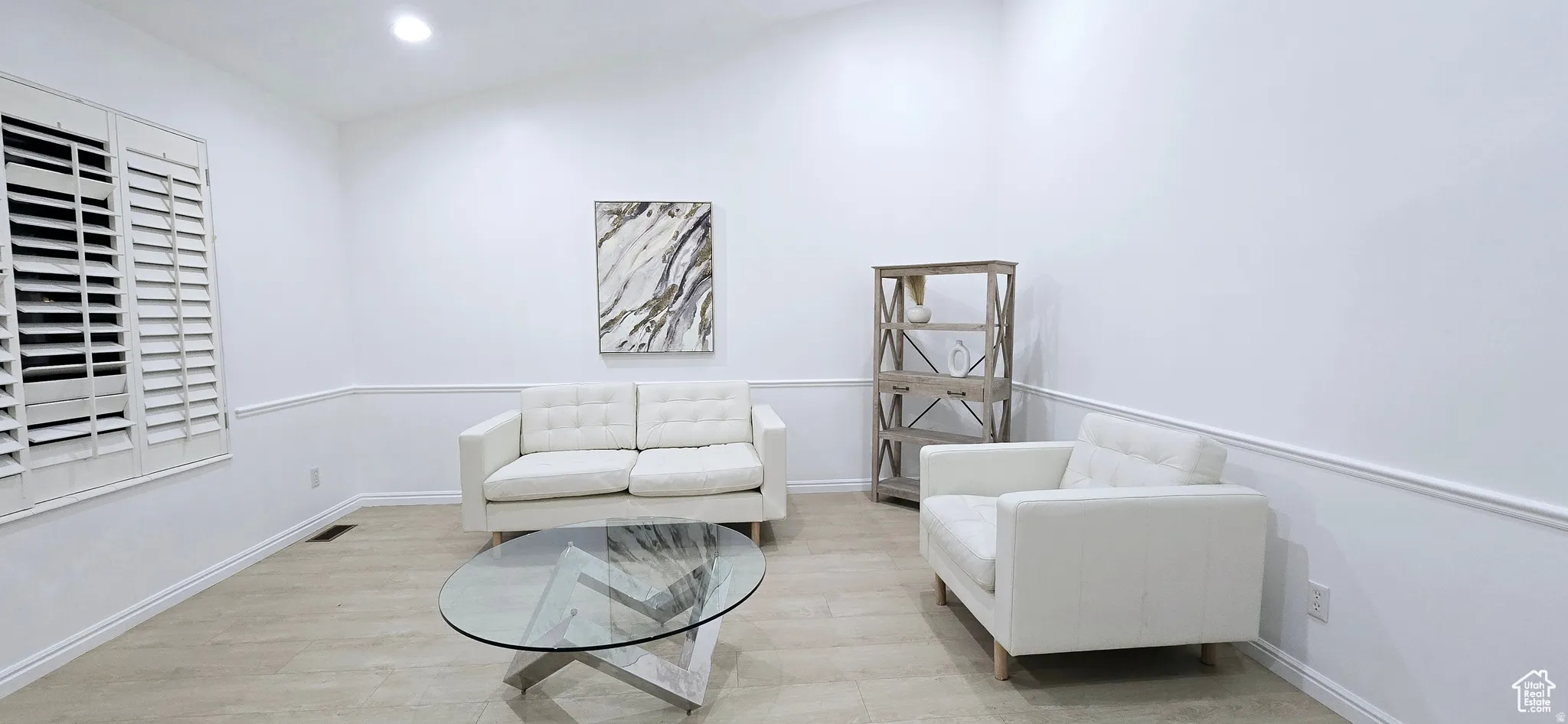 Living area featuring light wood-finish flooring and vaulted ceilings