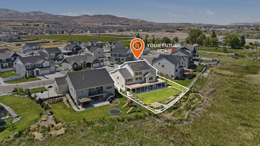 Two-story residence featuring a large rear deck and a spacious, landscaped backyard
