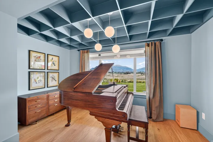 Coffered ceiling with integrated lighting and four spherical pendant fixtures