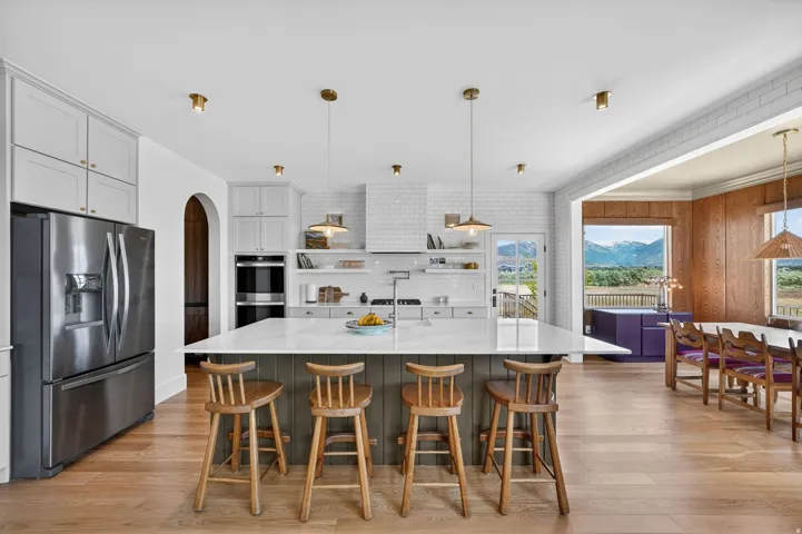 Light wood-finish flooring extending through an open-concept kitchen with a large central island