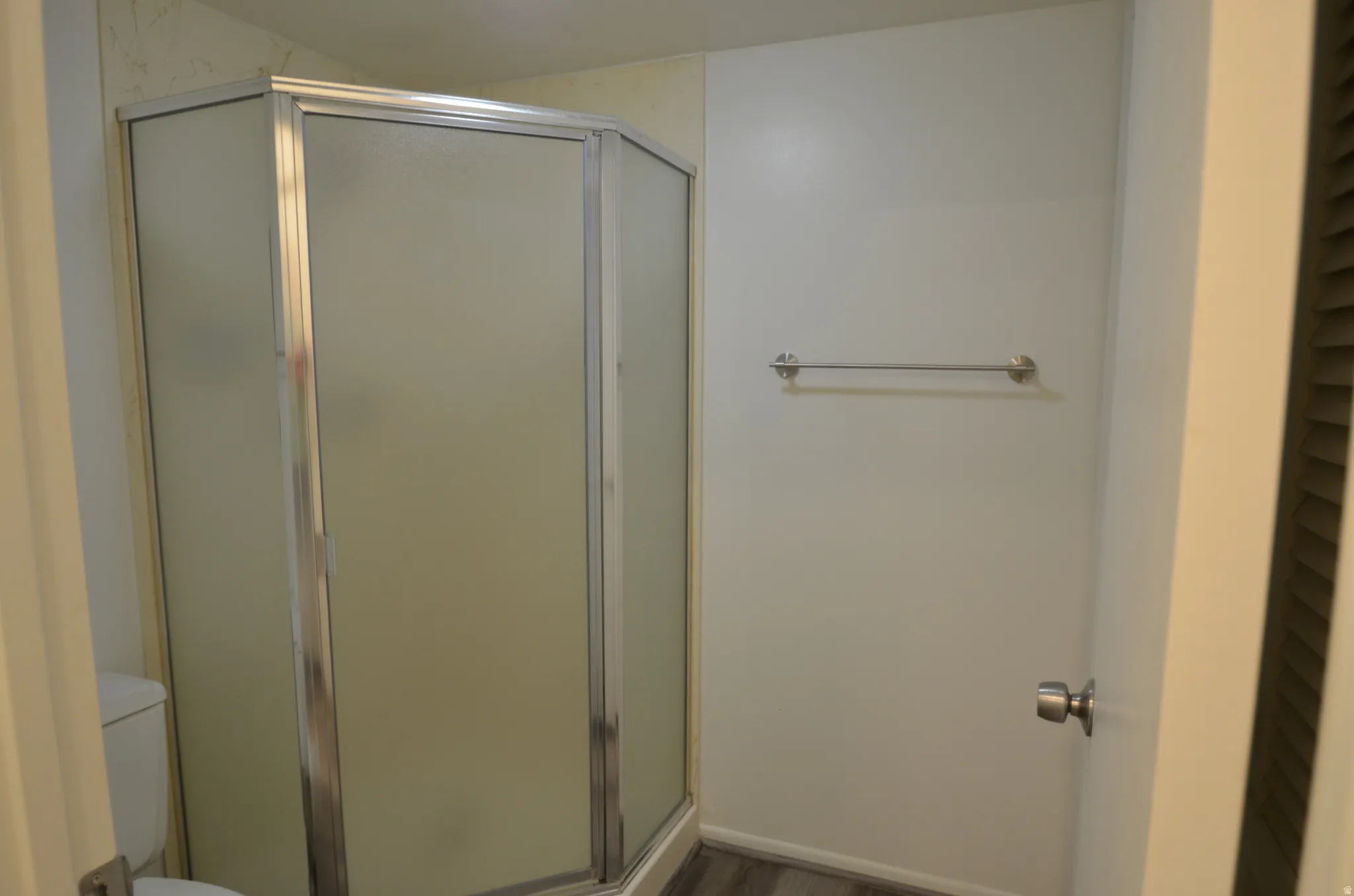 Main Bedroom corner shower enclosure with frosted glass panels and chrome framing