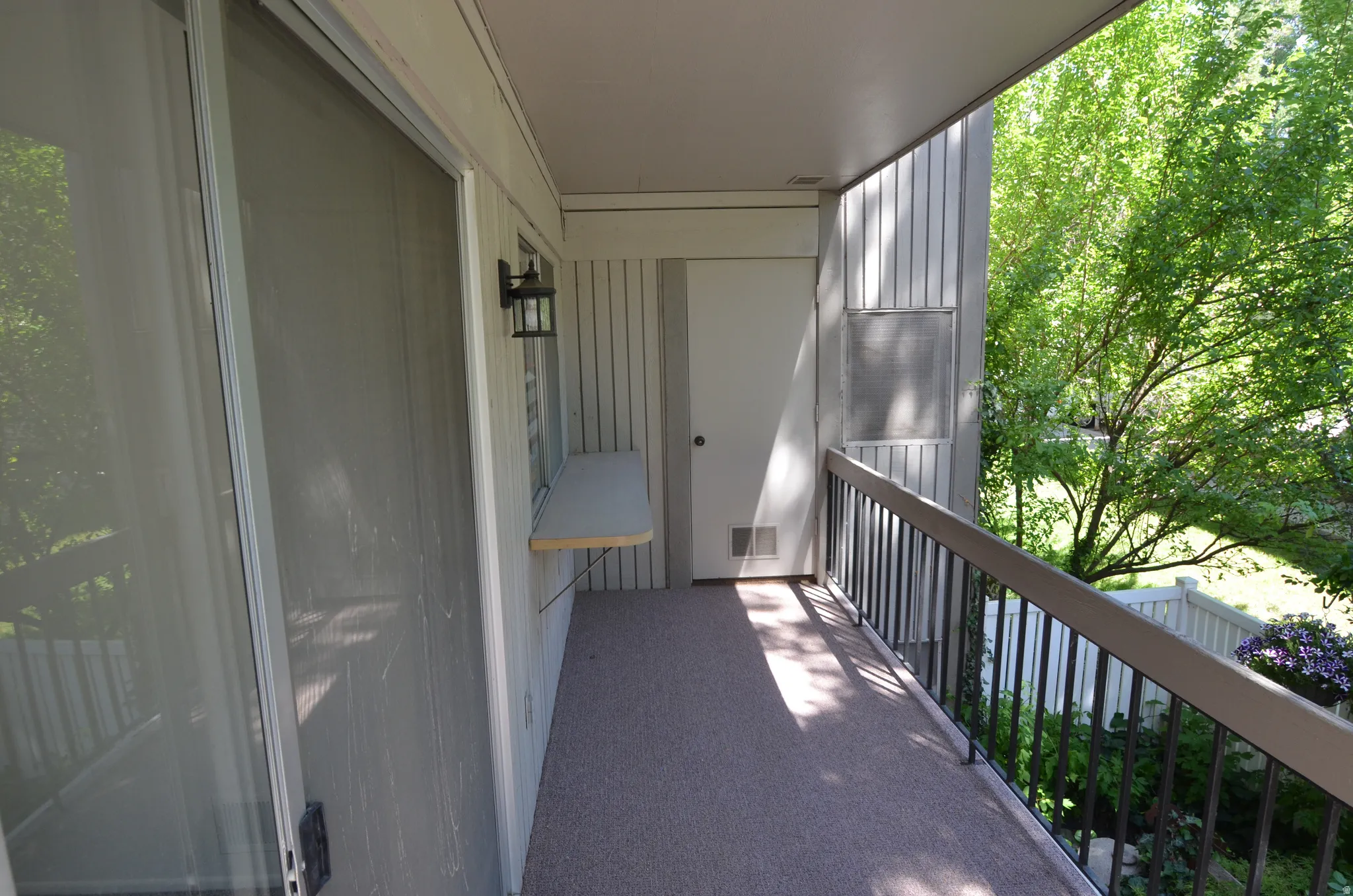 Deck off the front room with storage area