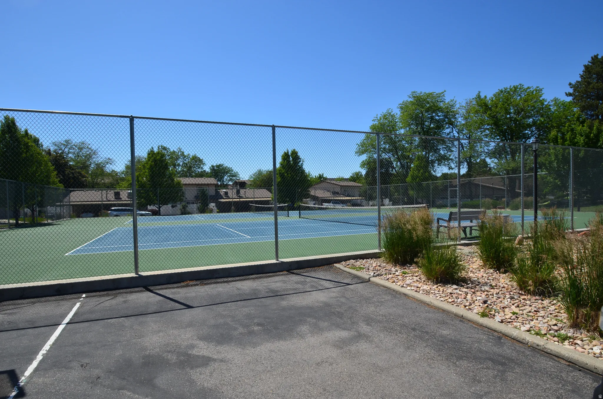 Community tennis courts with chain-link fencing