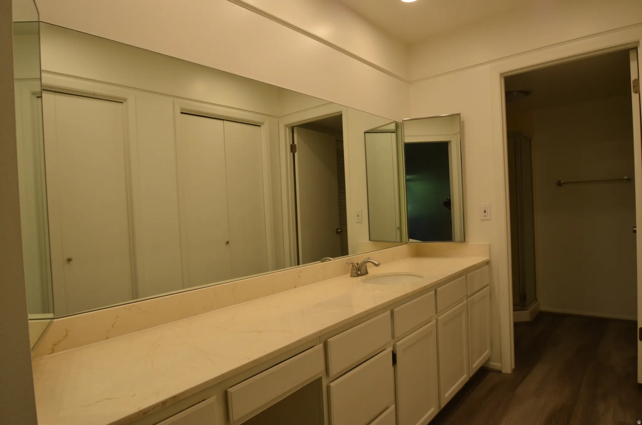 Main bedroom bathroom Vanity with a single undermount sink, a chrome faucet, and a stone-finish countertop