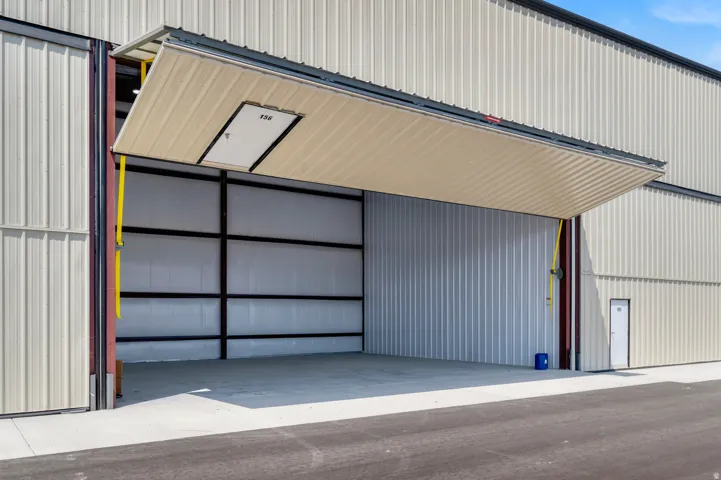 Corrugated metal exterior with a large bi-fold hangar door
