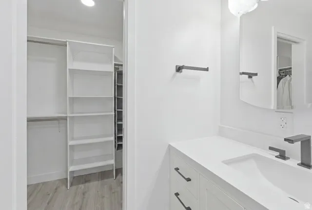Bathroom vanity with integrated sink, white countertop, and matte black fixtures