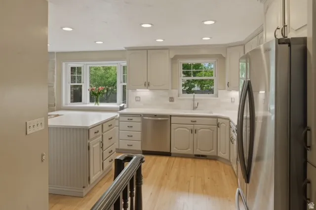 Kitchen featuring wood-finish flooring, recessed lighting, and light-toned cabinetry