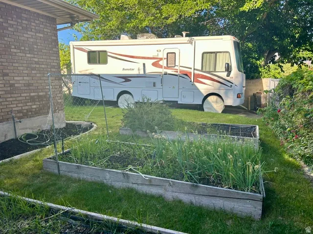 Garden area featuring two raised beds, established plantings, and a landscaped border