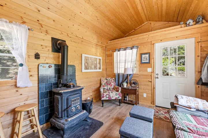 Interior with wood-paneled walls and a vaulted wood-plank ceiling