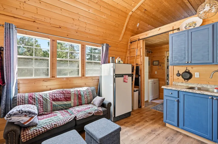 Wood-finish flooring throughout, complemented by wood plank walls and a wood plank vaulted ceiling