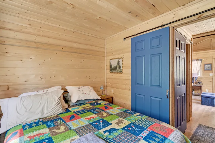 Wood-paneled room featuring a blue barn door